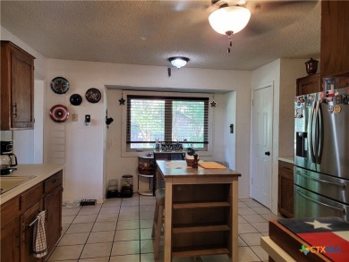 Enjoy a large main living room with a wood-burning fireplace on Hills of Cove Municipal Golf Course in Texas - for sale on GolfHomes.com, golf home, golf lot