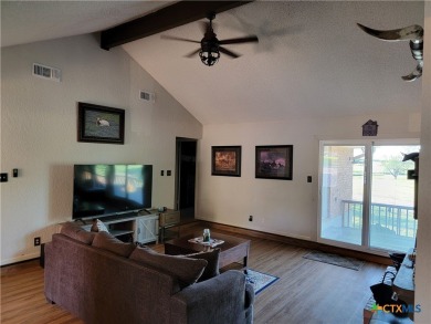 Enjoy a large main living room with a wood-burning fireplace on Hills of Cove Municipal Golf Course in Texas - for sale on GolfHomes.com, golf home, golf lot