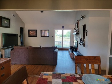 Enjoy a large main living room with a wood-burning fireplace on Hills of Cove Municipal Golf Course in Texas - for sale on GolfHomes.com, golf home, golf lot