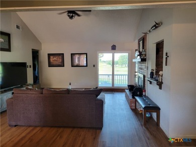 Enjoy a large main living room with a wood-burning fireplace on Hills of Cove Municipal Golf Course in Texas - for sale on GolfHomes.com, golf home, golf lot