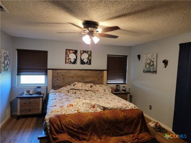 Enjoy a large main living room with a wood-burning fireplace on Hills of Cove Municipal Golf Course in Texas - for sale on GolfHomes.com, golf home, golf lot