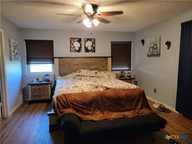 Enjoy a large main living room with a wood-burning fireplace on Hills of Cove Municipal Golf Course in Texas - for sale on GolfHomes.com, golf home, golf lot