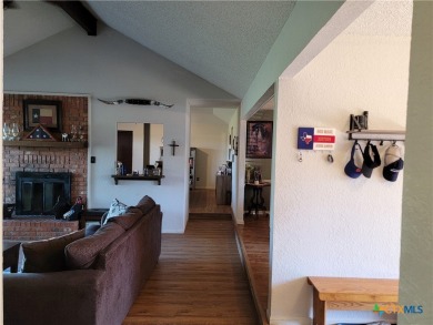 Enjoy a large main living room with a wood-burning fireplace on Hills of Cove Municipal Golf Course in Texas - for sale on GolfHomes.com, golf home, golf lot