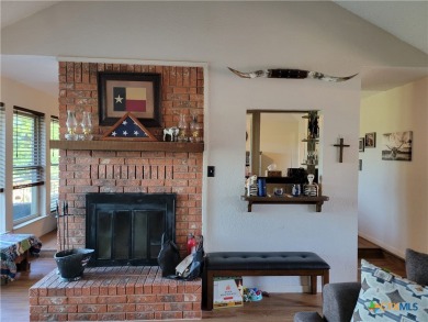 Enjoy a large main living room with a wood-burning fireplace on Hills of Cove Municipal Golf Course in Texas - for sale on GolfHomes.com, golf home, golf lot