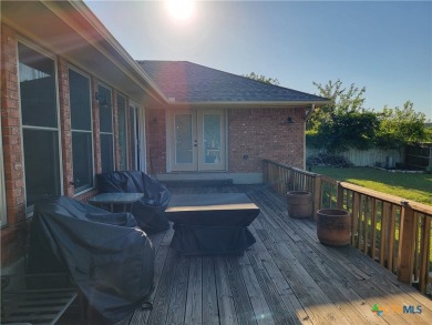 Enjoy a large main living room with a wood-burning fireplace on Hills of Cove Municipal Golf Course in Texas - for sale on GolfHomes.com, golf home, golf lot