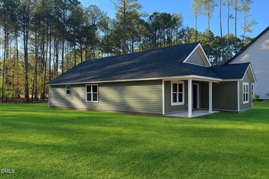 Welcome home to this charming three-bedroom, two-bath ranch on River Golf and Country Club at Lake Royale in North Carolina - for sale on GolfHomes.com, golf home, golf lot