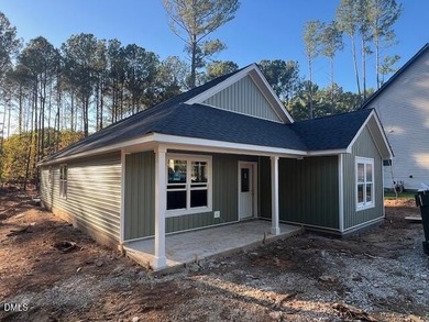 Welcome home to this charming three-bedroom, two-bath ranch on River Golf and Country Club at Lake Royale in North Carolina - for sale on GolfHomes.com, golf home, golf lot