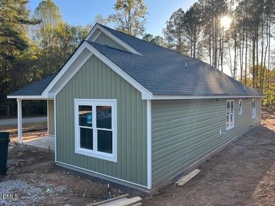 Welcome home to this charming three-bedroom, two-bath ranch on River Golf and Country Club at Lake Royale in North Carolina - for sale on GolfHomes.com, golf home, golf lot