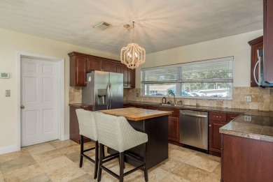 This beautifully updated three-bedroom, two-bathroom pool home on Largo Golf Course in Florida - for sale on GolfHomes.com, golf home, golf lot