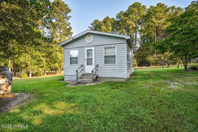 Escape to Lake Royale with this unique weekend retreat at 106 & on River Golf and Country Club at Lake Royale in North Carolina - for sale on GolfHomes.com, golf home, golf lot