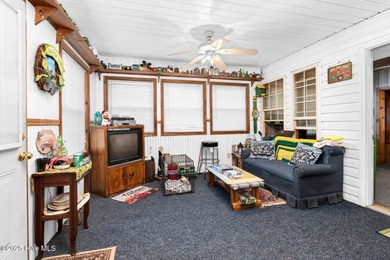 Escape to Lake Royale with this unique weekend retreat at 106 & on River Golf and Country Club at Lake Royale in North Carolina - for sale on GolfHomes.com, golf home, golf lot