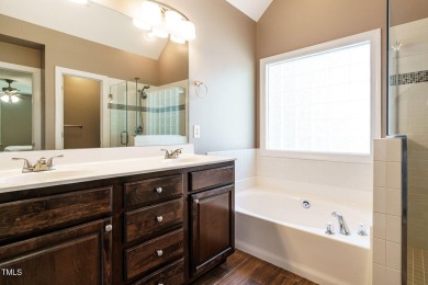 This exceptional property on a private wooded lot in the heart on Devils Ridge Golf Club in North Carolina - for sale on GolfHomes.com, golf home, golf lot