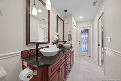 This 4BR/3BA CBS pool home sits on a private 1-acre cul-de-sac on Evergreen Club in Florida - for sale on GolfHomes.com, golf home, golf lot