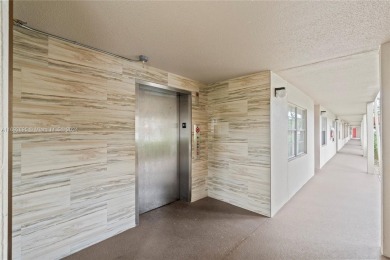 SPACIOUS UNIT WITH ACCORDIAN SHUTTERS AND A SCREENED BALCONY on Flamingo Lakes Country Club in Florida - for sale on GolfHomes.com, golf home, golf lot