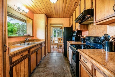 This recently remodeled two bedroom, two bath cabin is a on Volcano Golf and Country Club in Hawaii - for sale on GolfHomes.com, golf home, golf lot