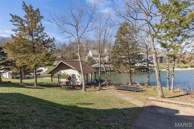 Welcome to the lake! This one is a turnkey waterfront lake house on Raintree Country Club in Missouri - for sale on GolfHomes.com, golf home, golf lot