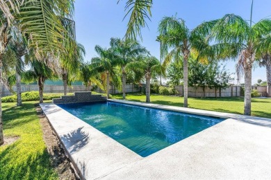 Gorgeous palm tree line down the sparkling inground pool with on South Padre Island Golf Club in Texas - for sale on GolfHomes.com, golf home, golf lot