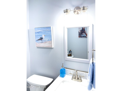 Discover this beautifully remodeled, brick traditional two-story on Oak Island Golf Club in North Carolina - for sale on GolfHomes.com, golf home, golf lot