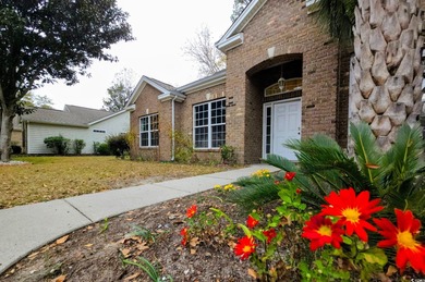 Located in a gated golf community, this brick-front 4-bed on Wachesaw Plantation East Golf Course in South Carolina - for sale on GolfHomes.com, golf home, golf lot