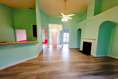 Located in a gated golf community, this brick-front 4-bed on Wachesaw Plantation East Golf Course in South Carolina - for sale on GolfHomes.com, golf home, golf lot