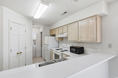 Welcome to this 2-bedroom, 2-bathroom first-floor condo located on River Oaks Golf Plantation  in South Carolina - for sale on GolfHomes.com, golf home, golf lot