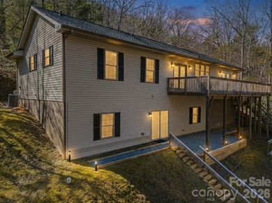 This recently renovated home with an open concept living space on Rumbling Bald Resort on Lake Lure in North Carolina - for sale on GolfHomes.com, golf home, golf lot