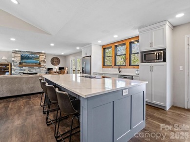 This recently renovated home with an open concept living space on Rumbling Bald Resort on Lake Lure in North Carolina - for sale on GolfHomes.com, golf home, golf lot