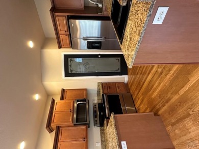 FABULOUS RANCHER WITH PARTIALLY FINISHED BASEMENT SHOWCASING AN on Desert Hawk At Pueblo West in Colorado - for sale on GolfHomes.com, golf home, golf lot