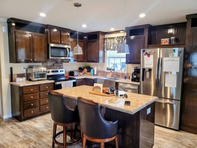 This open floor plan starts with a covered country rocking chair on Water Oak Country Club Estates in Florida - for sale on GolfHomes.com, golf home, golf lot