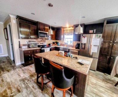 This open floor plan starts with a covered country rocking chair on Water Oak Country Club Estates in Florida - for sale on GolfHomes.com, golf home, golf lot