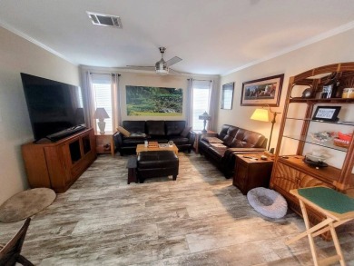 This open floor plan starts with a covered country rocking chair on Water Oak Country Club Estates in Florida - for sale on GolfHomes.com, golf home, golf lot