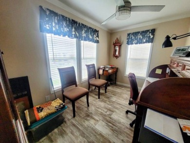 This open floor plan starts with a covered country rocking chair on Water Oak Country Club Estates in Florida - for sale on GolfHomes.com, golf home, golf lot