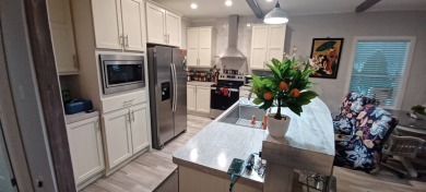 Come settle down and relax in a beautiful, manufactured home on Fairways Country Club in Florida - for sale on GolfHomes.com, golf home, golf lot