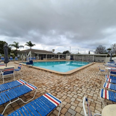 Come settle down and relax in a beautiful, manufactured home on Fairways Country Club in Florida - for sale on GolfHomes.com, golf home, golf lot