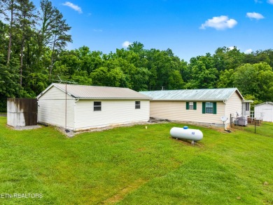 Endless possibilities await with this charming 2 bed/1 bath home on Dandridge Golf and Country Club in Tennessee - for sale on GolfHomes.com, golf home, golf lot