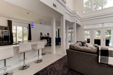 Stunning contemporary architecture frames the wide open interior on Plantation Bay Golf and Country Club in Florida - for sale on GolfHomes.com, golf home, golf lot