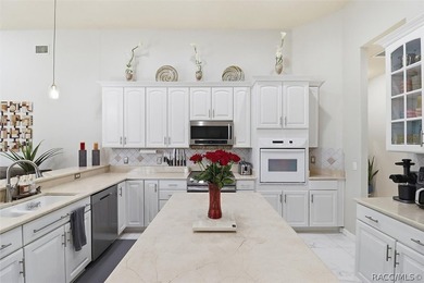 Nestled beneath a canopy of mature oaks on a lush, expansive lot on Citrus Hills Golf Club in Florida - for sale on GolfHomes.com, golf home, golf lot