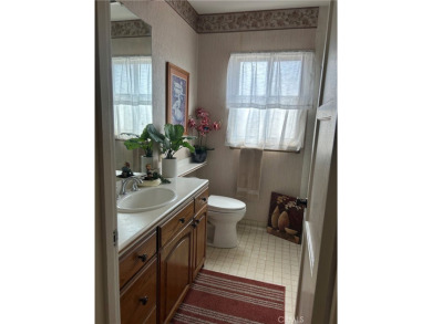 This single-story home situated in South of Conant neighborhood on Skylinks At Long Beach Golf Course in California - for sale on GolfHomes.com, golf home, golf lot