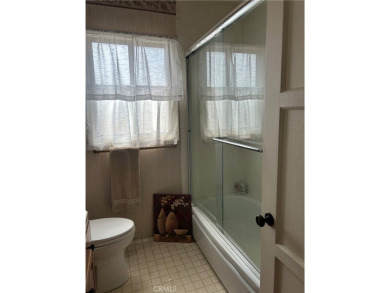 This single-story home situated in South of Conant neighborhood on Skylinks At Long Beach Golf Course in California - for sale on GolfHomes.com, golf home, golf lot