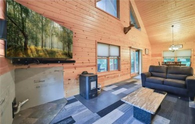 Experience the charm of this stunning log home on Northwood on Hardwoods Golf Club At Mille Lacs in Minnesota - for sale on GolfHomes.com, golf home, golf lot