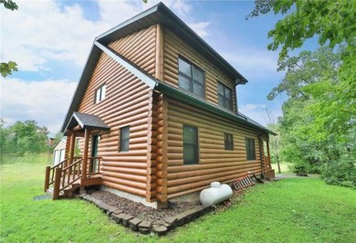 Experience the charm of this stunning log home on Northwood on Hardwoods Golf Club At Mille Lacs in Minnesota - for sale on GolfHomes.com, golf home, golf lot