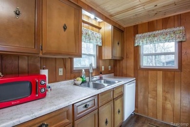 Welcome to your Up North getaway or your year round home inside on Lost Lake Woods Club in Michigan - for sale on GolfHomes.com, golf home, golf lot