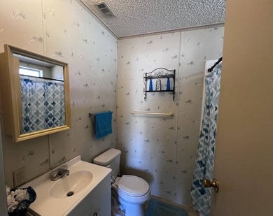 This 940 sq ft home offers an open floor plan and a bright on Lake Henry Golf Club in Florida - for sale on GolfHomes.com, golf home, golf lot