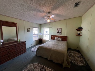 This 940 sq ft home offers an open floor plan and a bright on Lake Henry Golf Club in Florida - for sale on GolfHomes.com, golf home, golf lot