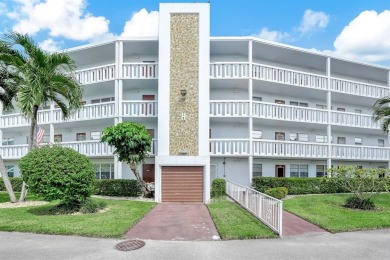 Experience serene waterfront living in this beautifully on Hillsboro Pines Golf in Florida - for sale on GolfHomes.com, golf home, golf lot