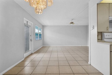 Experience serene waterfront living in this beautifully on Hillsboro Pines Golf in Florida - for sale on GolfHomes.com, golf home, golf lot