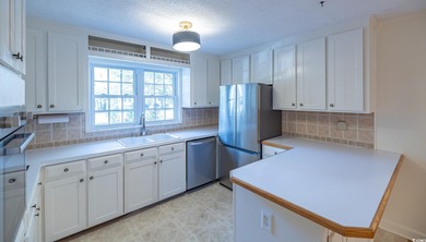 Set on a generous lot with wooded surroundings and views of the on The Founders Club At Pawleys Island in South Carolina - for sale on GolfHomes.com, golf home, golf lot