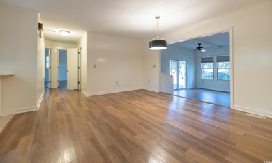 Set on a generous lot with wooded surroundings and views of the on The Founders Club At Pawleys Island in South Carolina - for sale on GolfHomes.com, golf home, golf lot