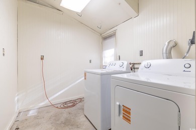 Set on a generous lot with wooded surroundings and views of the on The Founders Club At Pawleys Island in South Carolina - for sale on GolfHomes.com, golf home, golf lot