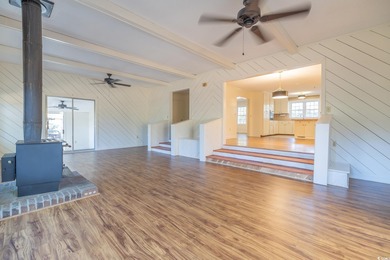 Set on a generous lot with wooded surroundings and views of the on The Founders Club At Pawleys Island in South Carolina - for sale on GolfHomes.com, golf home, golf lot